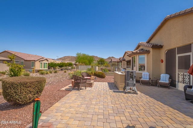 17540 W Glenhaven Dr, Goodyear, AZ 85338 - view of patio / terrace featuring fence and a mountain view