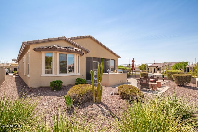 17540 W Glenhaven Dr, Goodyear, AZ 85338 - exterior space featuring fence, a tile roof, stucco siding, and a patio