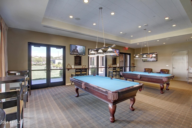 rec room featuring billiards, a tray ceiling, and french doors