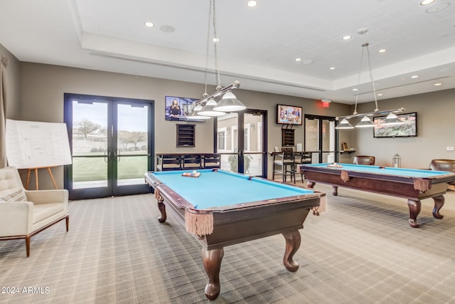 game room with billiards, light colored carpet, a raised ceiling, and french doors