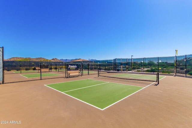 17540 W Glenhaven Dr, Goodyear, AZ 85338 - view of tennis court featuring community basketball court, fence, and a mountain view