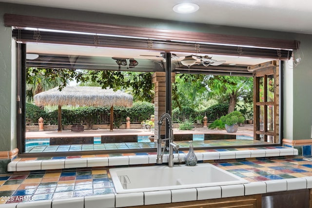 kitchen view of a sink and tile counters