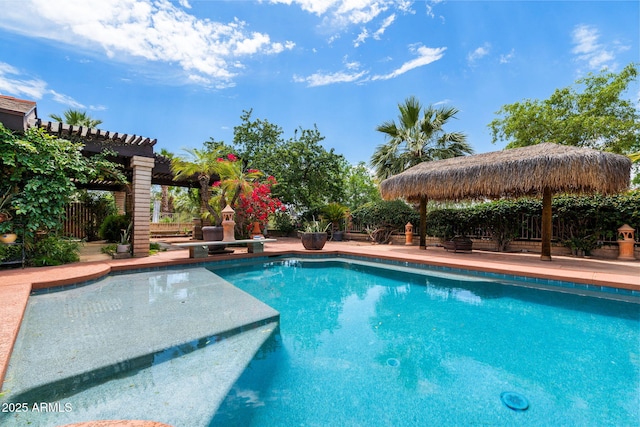 swimming pool with a diving board and a fenced backyard