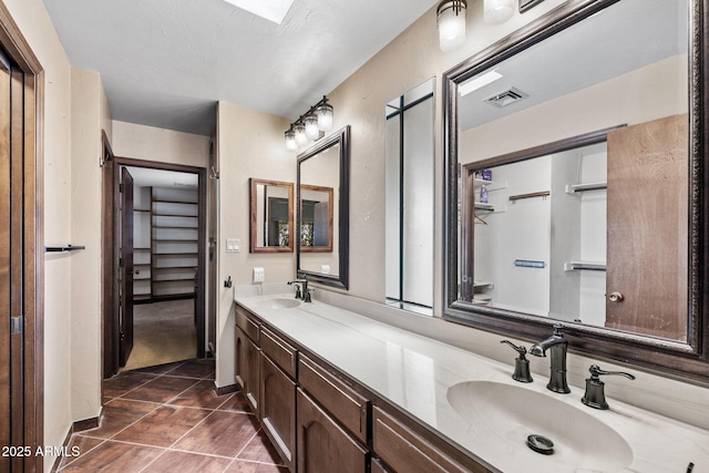 full bath featuring tile patterned flooring and double vanity