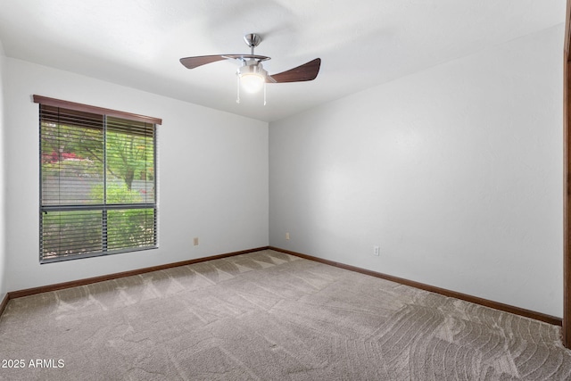 empty room featuring carpet floors, baseboards, and ceiling fan