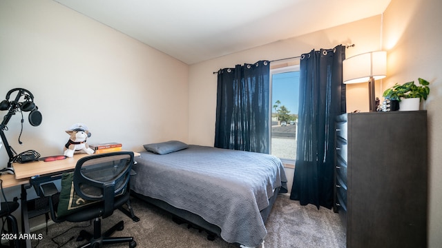 carpeted bedroom featuring lofted ceiling