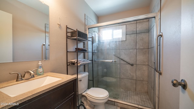 bathroom featuring walk in shower, vanity, and toilet