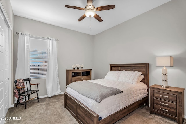 carpeted bedroom with a ceiling fan and baseboards