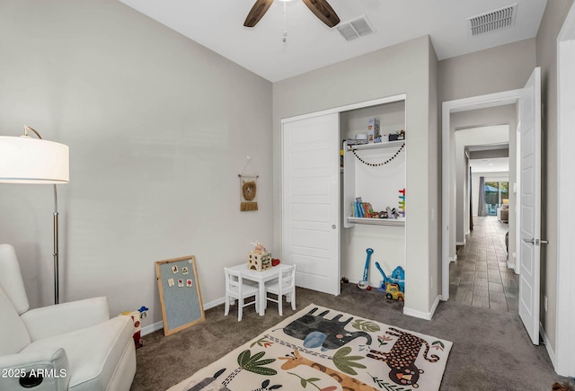 rec room featuring baseboards, ceiling fan, carpet, and visible vents