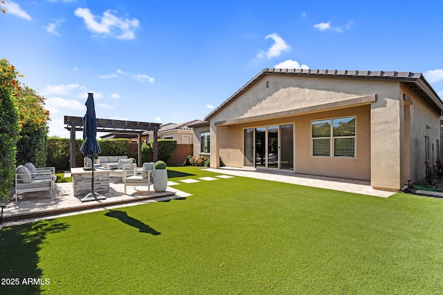 rear view of house with a pergola, stucco siding, outdoor lounge area, a patio area, and a lawn