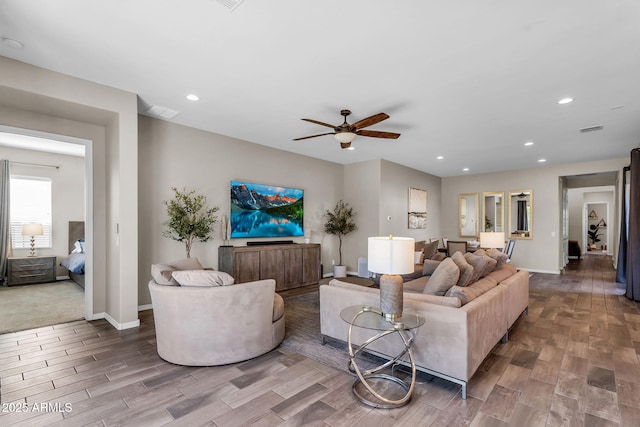 living area featuring a ceiling fan, recessed lighting, wood finished floors, and visible vents