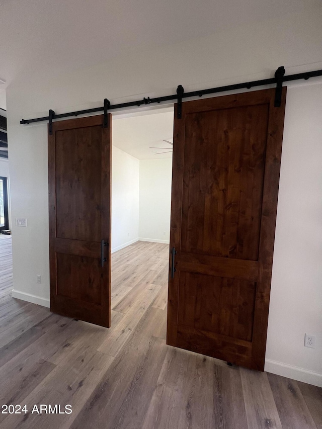 interior space with hardwood / wood-style flooring and a barn door