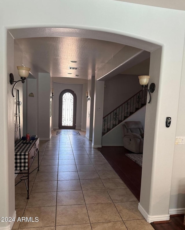 tiled entrance foyer featuring a textured ceiling