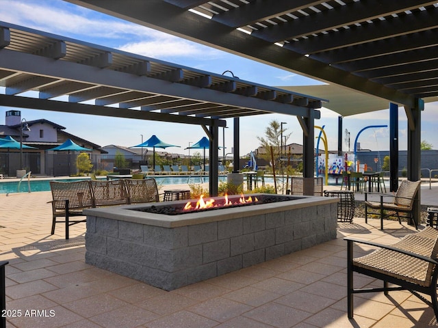 view of patio featuring an outdoor fire pit, a pergola, a community pool, and fence