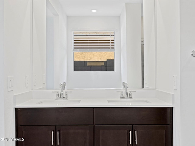 full bathroom with a sink and double vanity