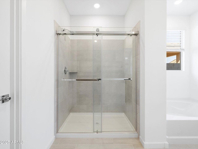 full bathroom with a shower stall, a garden tub, recessed lighting, and baseboards