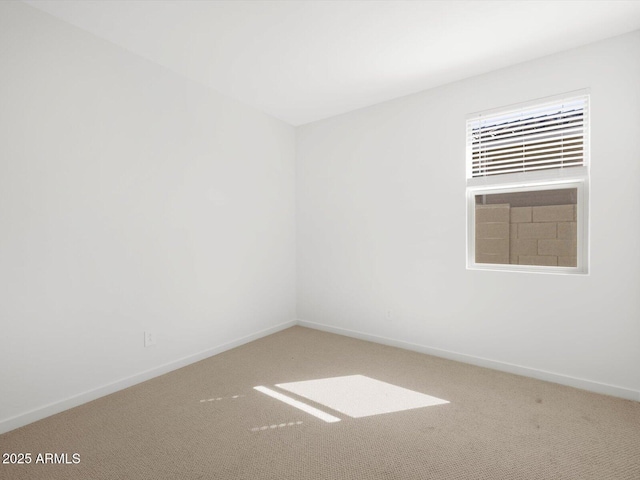 empty room featuring baseboards and carpet floors