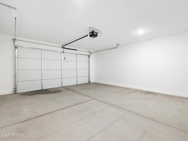 garage with baseboards and a garage door opener