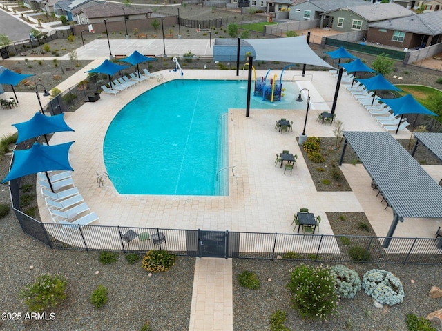 community pool featuring a water play area and fence