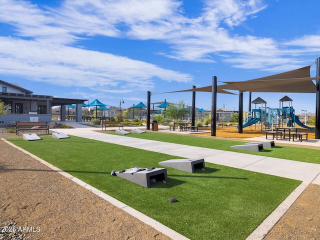 view of home's community with playground community and a yard