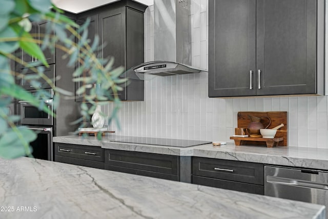 kitchen featuring wall chimney exhaust hood, black electric cooktop, stainless steel dishwasher, light stone countertops, and decorative backsplash