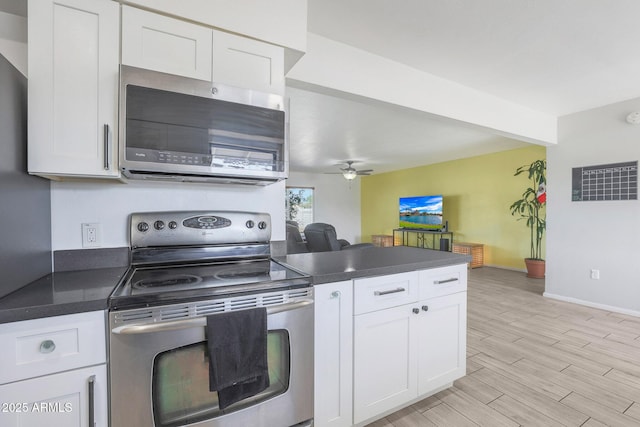 kitchen featuring ceiling fan, appliances with stainless steel finishes, and white cabinets