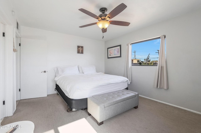 bedroom with light carpet and ceiling fan