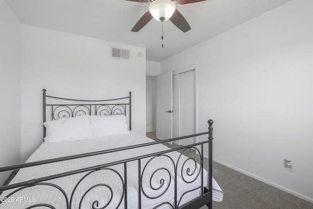 carpeted bedroom with ceiling fan and a closet