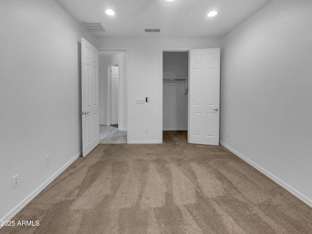 unfurnished bedroom with visible vents, baseboards, and carpet