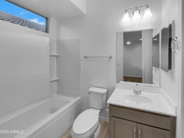 bathroom with toilet, vanity, and washtub / shower combination