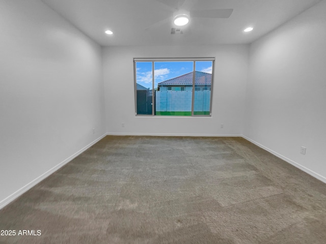 empty room with visible vents, baseboards, and carpet