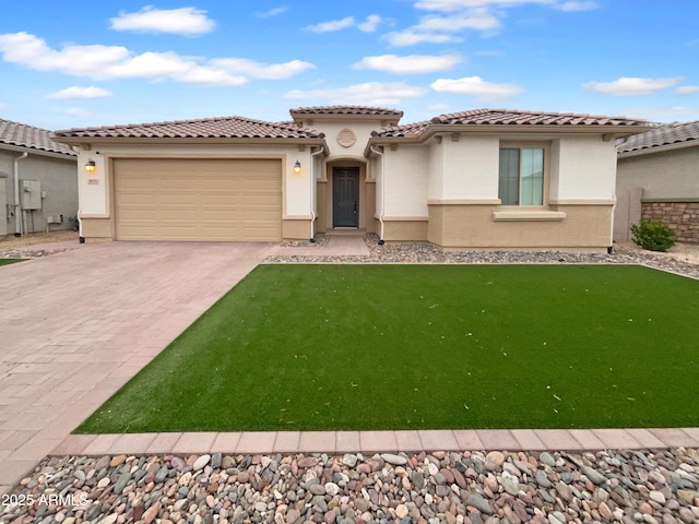 mediterranean / spanish-style house with stucco siding, a front lawn, driveway, an attached garage, and a tiled roof