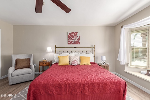 bedroom with wood finished floors, baseboards, and ceiling fan