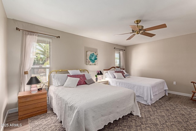 bedroom featuring ceiling fan, light wood-type flooring, and baseboards