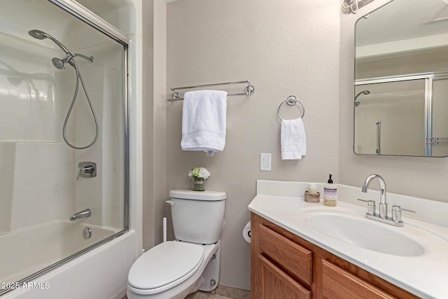 bathroom featuring vanity, toilet, and combined bath / shower with glass door