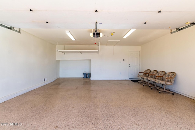 garage with a garage door opener and baseboards