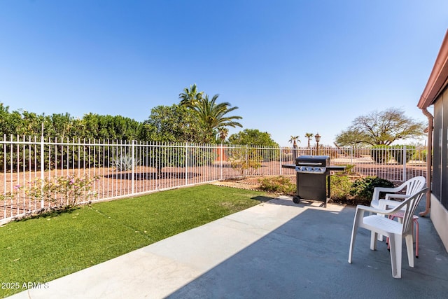 view of patio with area for grilling and a fenced backyard