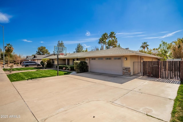 single story home with an attached garage, driveway, stone siding, stucco siding, and a front lawn