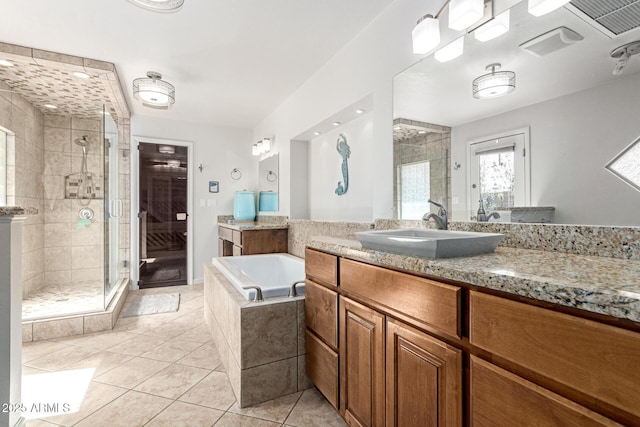 full bath featuring a stall shower, tile patterned flooring, a bath, and vanity