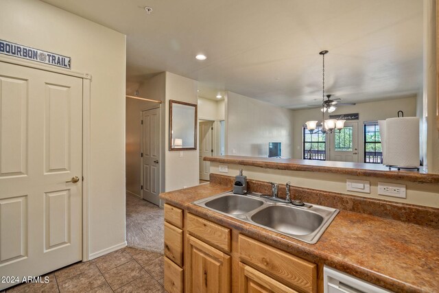 kitchen with light tile patterned flooring, sink, ceiling fan, and hanging light fixtures