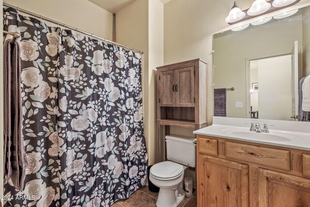 bathroom with tile patterned flooring, toilet, and vanity