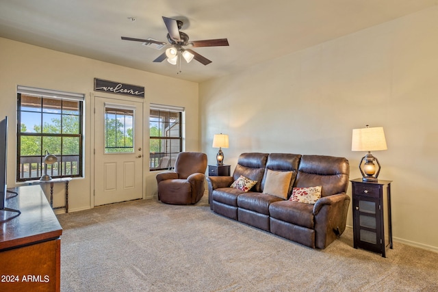 carpeted living room with ceiling fan