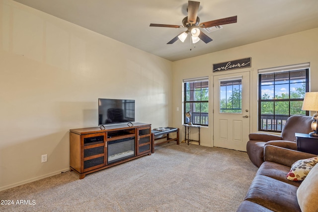 carpeted living room with ceiling fan