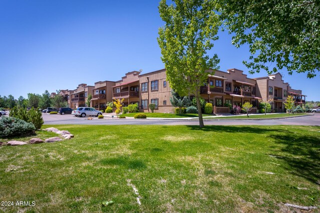 view of home's community featuring a lawn