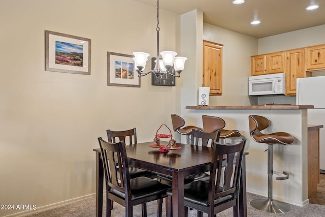 dining room featuring a chandelier and carpet