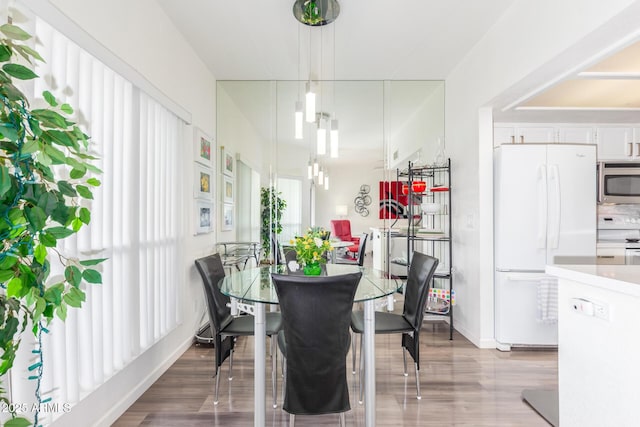 dining area featuring wood finished floors and baseboards