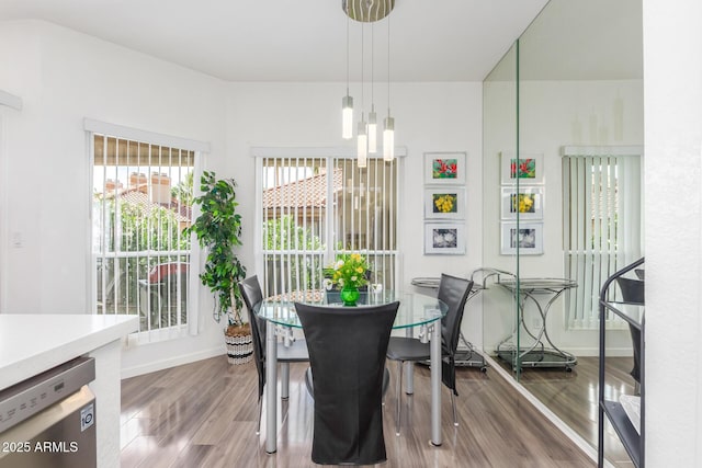 dining area with wood finished floors and baseboards