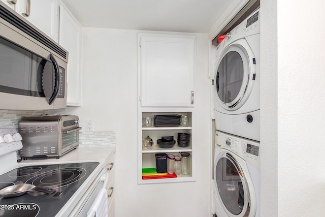 laundry room with stacked washer / dryer, laundry area, and a toaster