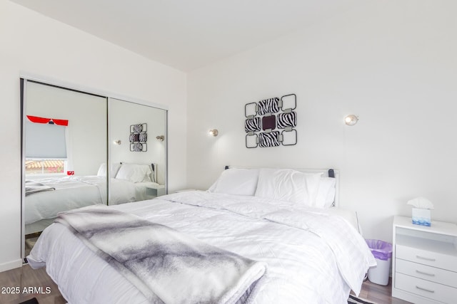 bedroom with a closet and wood finished floors