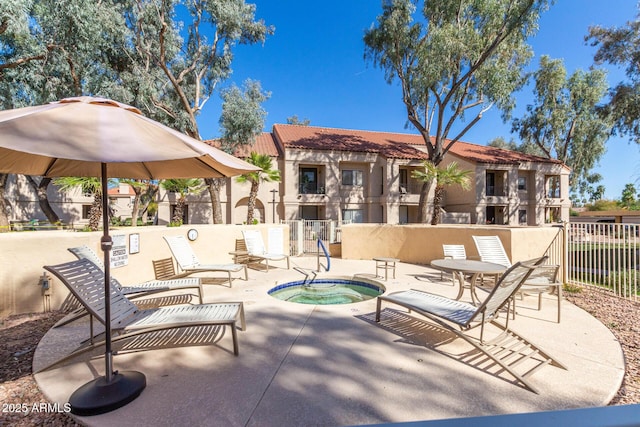 view of patio / terrace with fence and a community hot tub